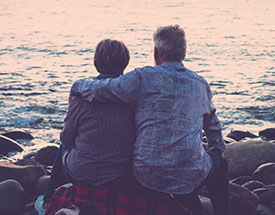 A couple sitting on the coast
