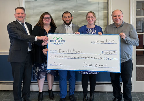 BHBT employees present a donation to David's House