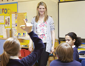 A teacher talks to young students