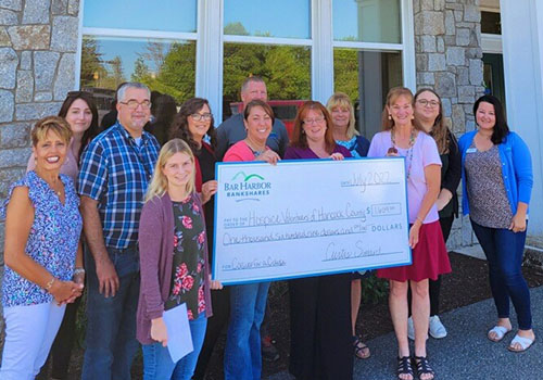 BHBT employees present a check to Hospice Volunteers of Hancock County