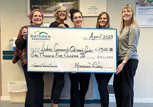 BHBT employees present a donation to Lubec Community Outreach Center