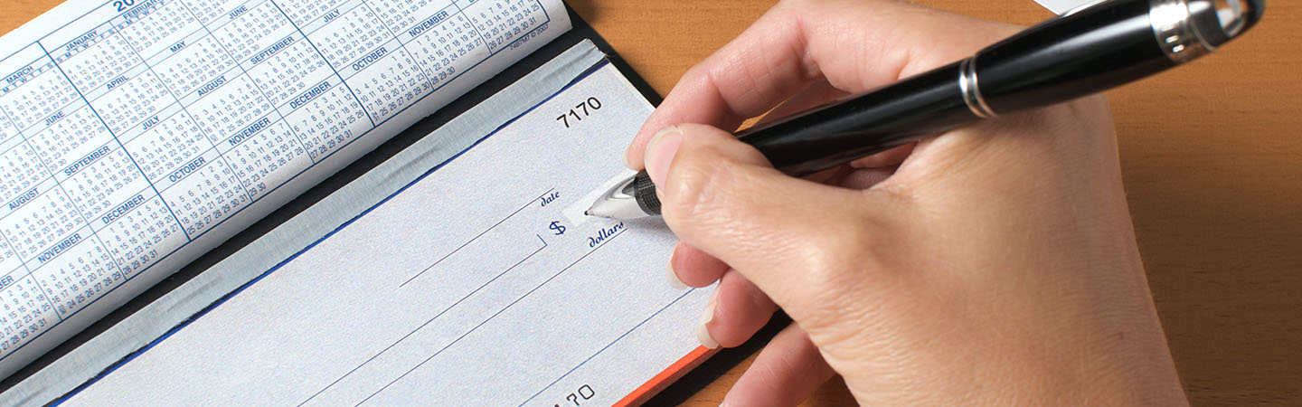 A person writing a check