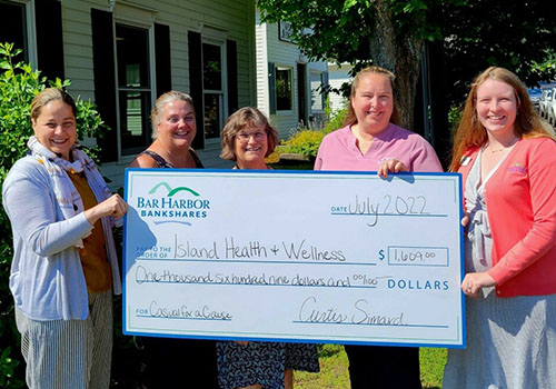 BHBT employees present a check to Island Health & Wellness Foundation