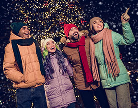 Group of friends enjoying holiday lights