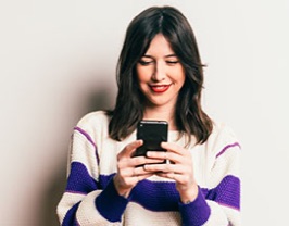 A young woman holding a smartphone.