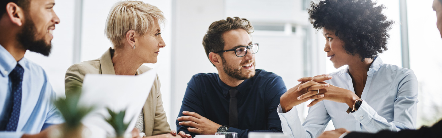 A group of people in an office meeting.