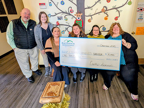 BHBT employees present a donation to Emmaus Homeless Shelter