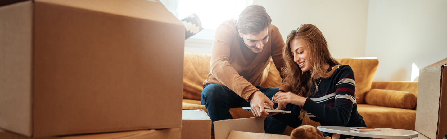 A couple surrounded by moving boxes