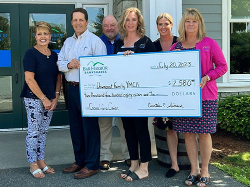 BHBT employees present a donation to Down East Family YMCA