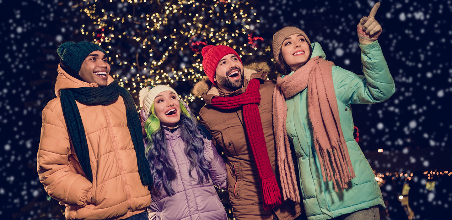 Group of friends enjoying holiday lights