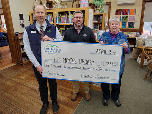 BHBT employees present a donation to Henry D. Moore Parish House & Library