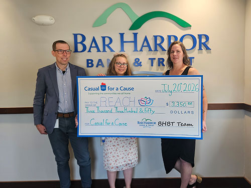 BHBT employees present a donation to REACH Crisis Services