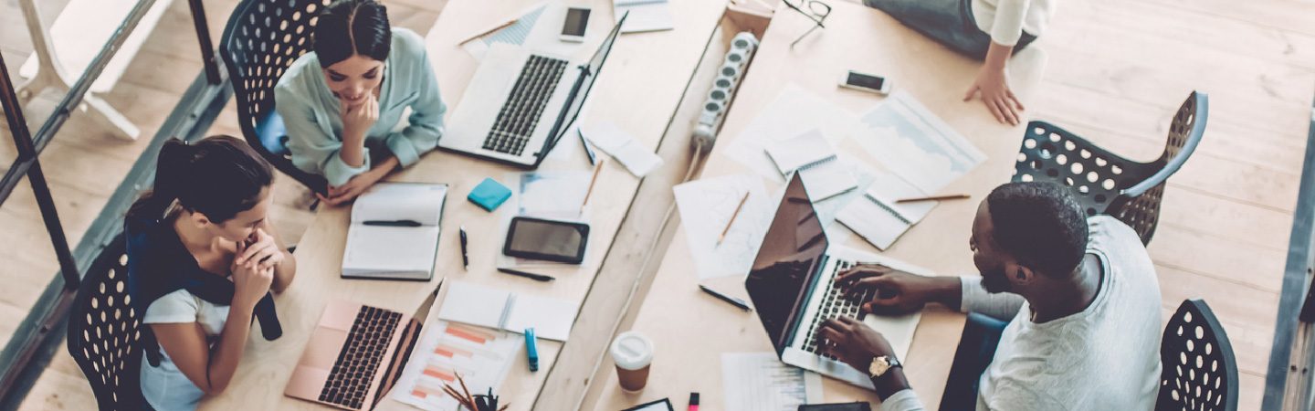 Overhead view of multiple people working in an office.