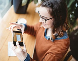 A young woman holding a smartphone.