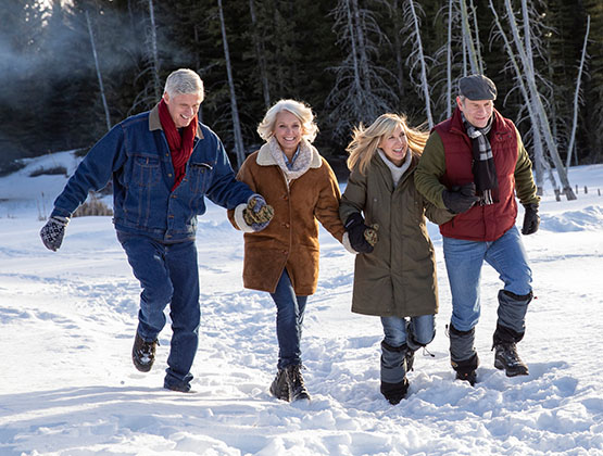 A group of mature adults walking through snow