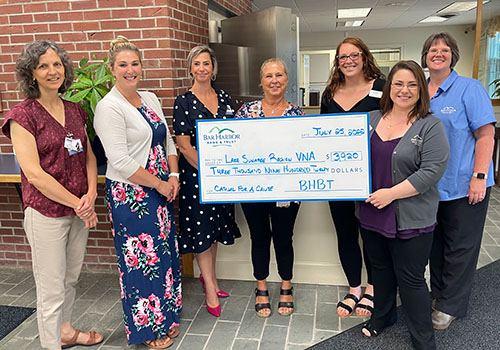 BHBT employees present a check to Lake Sunapee Region VNA & Hospice