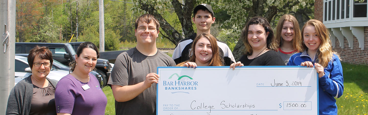 Students holding a check