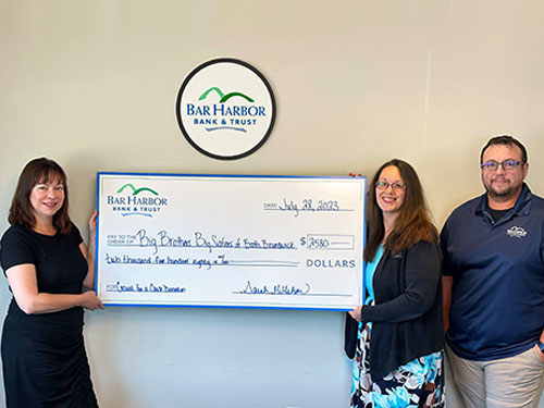 BHBT employees present a donation to Big Brothers Big Sisters of Bath/Brunswick