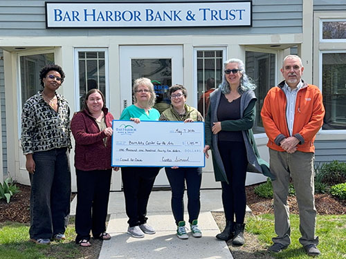 BHBT employees present a donation to BarnArts Center for the Arts