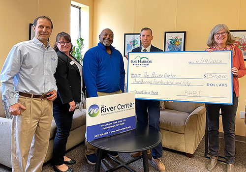 BHBT employees present a donation to The River Center