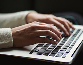 Person typing on a keyboard