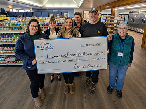 BHBT employees present a donation to Loaves & Fishes Food Pantry