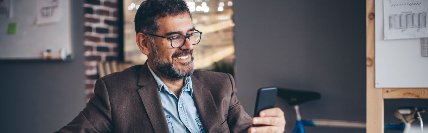 A man looking at a mobile phone