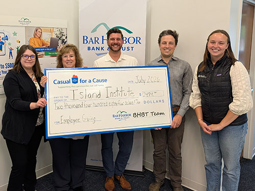 BHBT employees present a donation to Island Institute