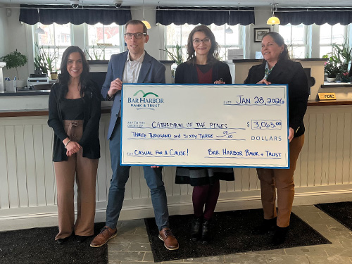 BHBT employees present a donation to Cathedral of the Pines