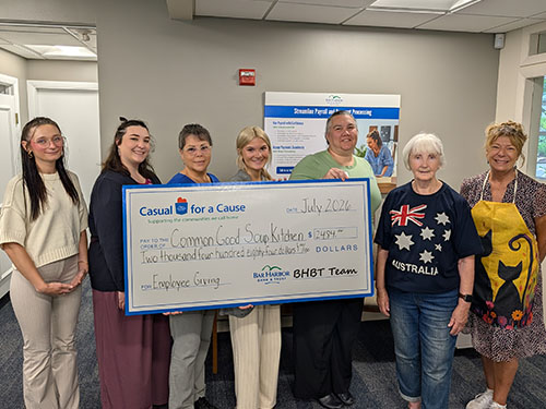 BHBT employees present a donation to Common Good Soup Kitchen