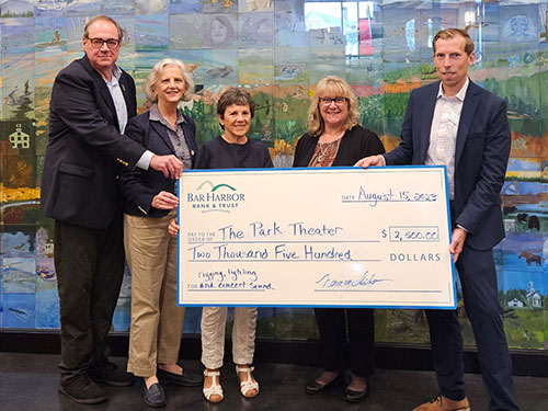 Employees present a donation to The Park Theatre
