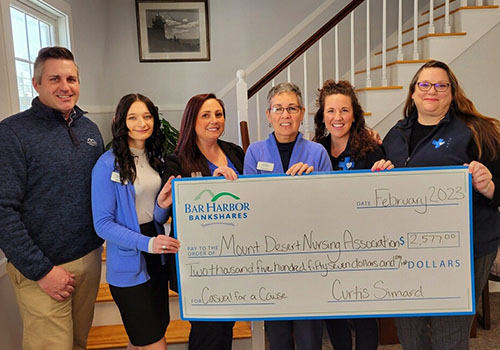 BHBT employees present a donation to Mount Desert Nursing Association