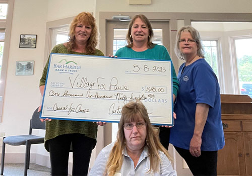 BHBT employees present a donation to Village for Paws Rescue