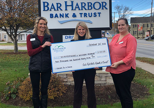 BHBT employees present a check to NeighborWorks of Western Vermont