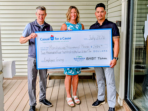 BHBT employees present a donation to Manufacturers Association of Maine