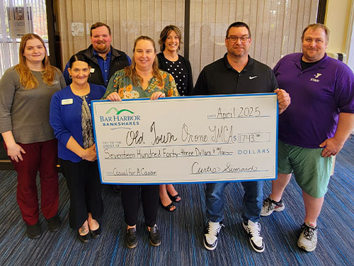 BHBT employees present a donation to Old Town-Orono YMCA