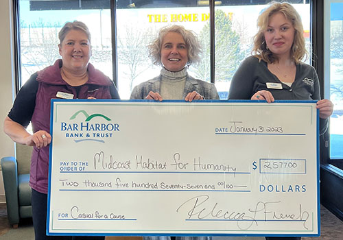 BHBT employees present a donation to Midcoast Habitat for Humanity