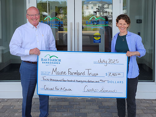 BHBT employee presents a donation to Maine Farmland Trust