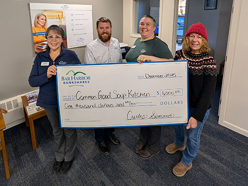BHBT employees present a donation to Common Good Soup Kitchen
