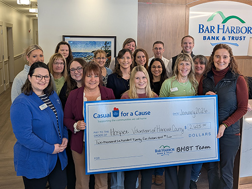 BHBT employees present a donation to Hospice Volunteers of Hancock County