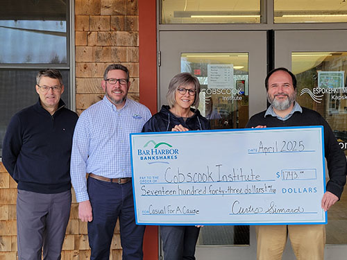 BHBT employees present a donation to Cobscook Institute