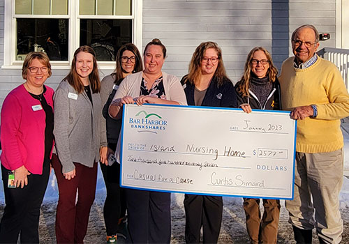 BHBT employees present a donation to Island Nursing Home