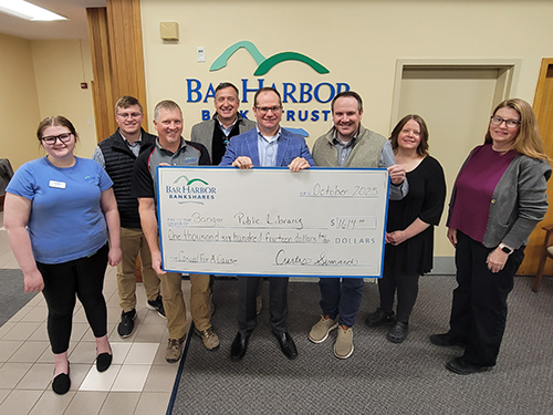 BHBT employees make a donation to Bangor Public Library
