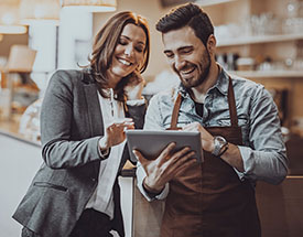 Image of two people looking at a tablet