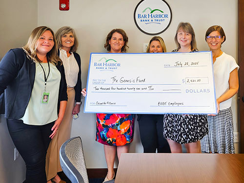 BHBT employees present a donation to The Genesis Fund
