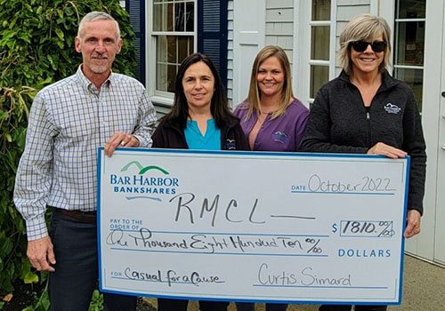 BHBT employees present a check to Regional Medical Center at Lubec