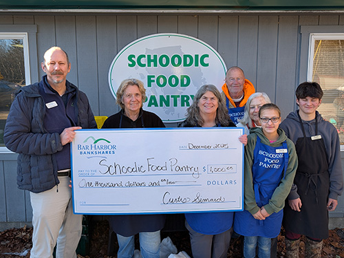 BHBT employees present a donation to Schoodic Food Pantry