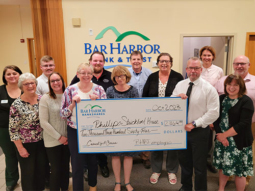 BHBT employees present a donation to Phillips-Strickland House
