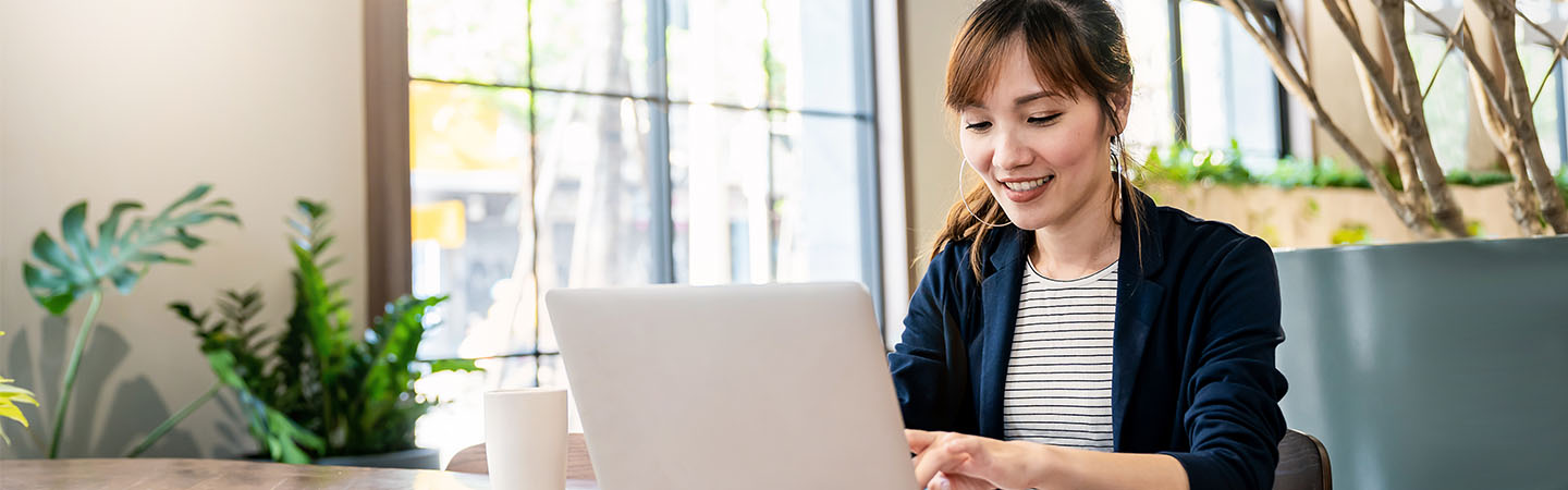 A woman typing on a laptop