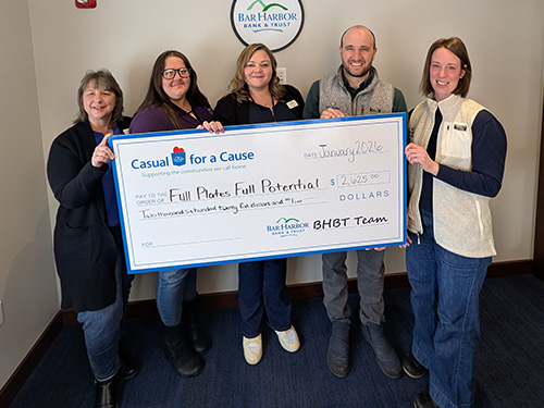 BHBT employees present a donation to Full Plates Full Potential